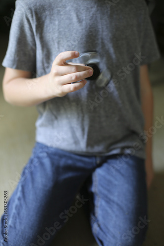 Little Boy Playing with a Fidget Spinner © holly
