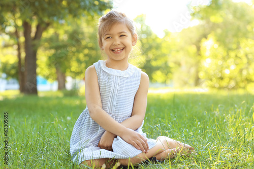 Cute little girl sitting on...