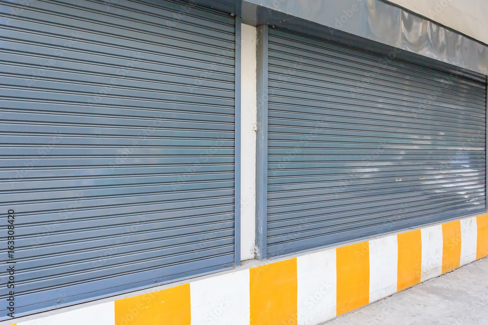 Fototapeta premium Steel roller shutter automatic door on the street.