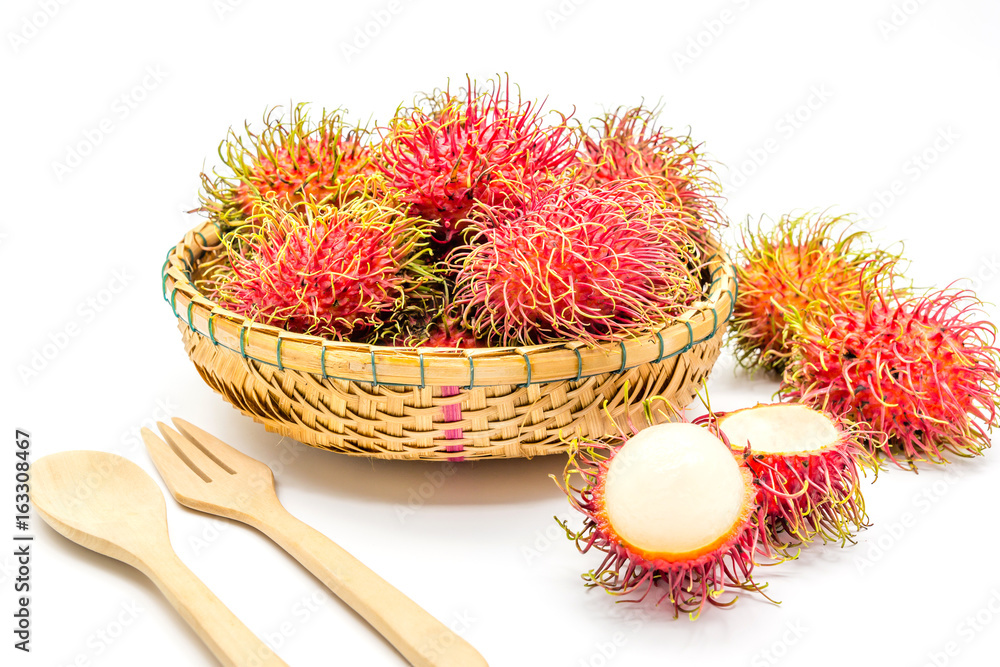 fresh tropical rambutan fruits over basket with spoon and fork on a white background, fruit in Thailand fresh tropical rambutan fruits over basket with spoon and fork on a white background, fruit in Thailand