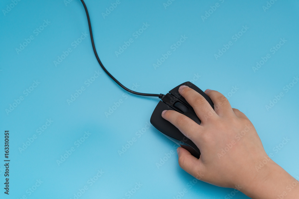 kid using a black mouse on a blue background kid using a black mouse on a blue background