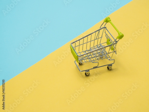 Collection of shopping cart full of shopping time.Top view or flat lay composition cart on color background.