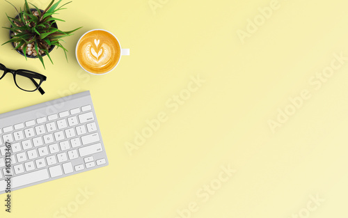 Modern workspace with keyboard and coffee cup copy space on color background. Top view. Flat lay style.
