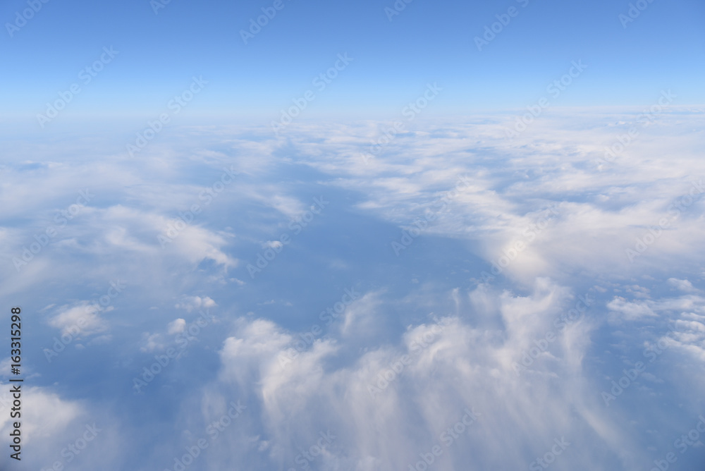Aerial view of white clouds in the blue sky, Beautiful view from airplane window Aerial view of white clouds in the blue sky, Beautiful view from airplane window
