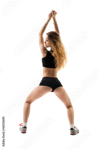 Sexy girl doing sports exercises in studio