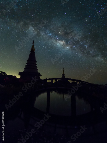 Silhouette pagoda with milky way in dark night at Doi Inthanon, Chiangmai, Thailand