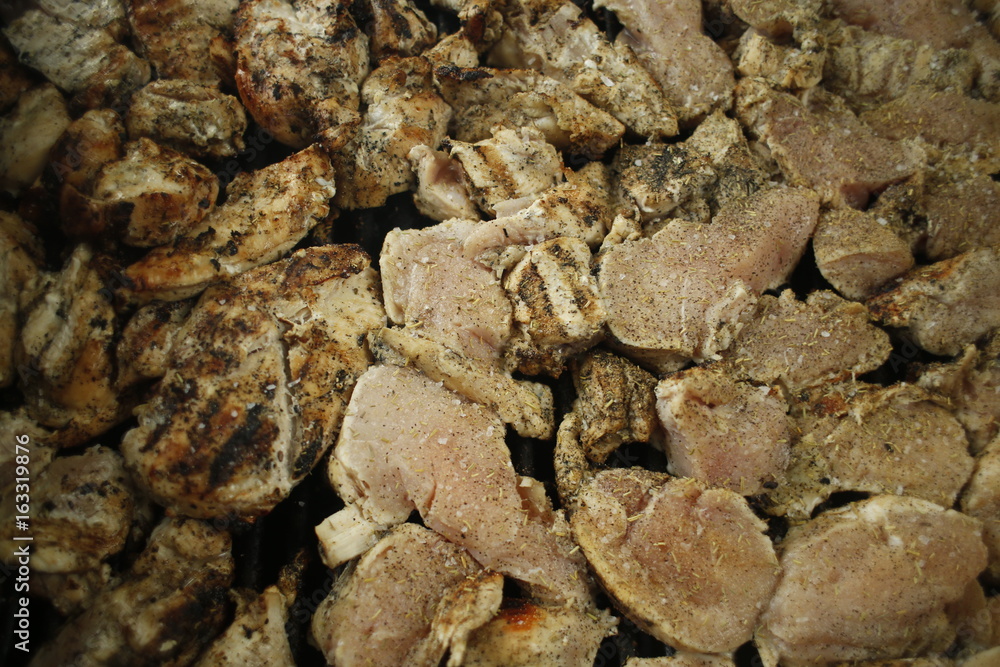 Grilling chicken breasts during 4th of July BBQ 