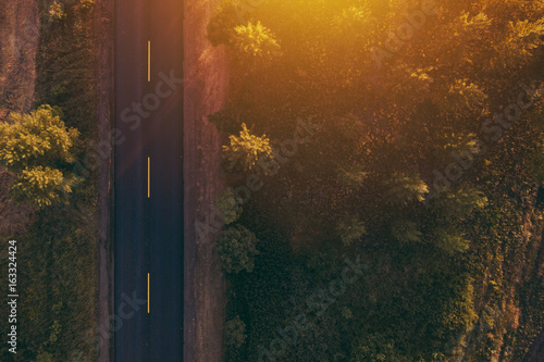 Εκτύπωση καμβά Empty road through countryside in sunset, aerial view drone pov