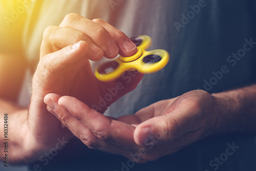 Man playing with fidget spinner