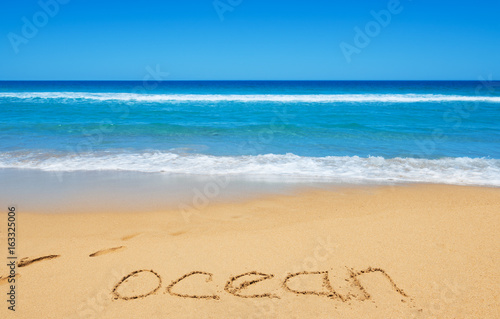 Ocean message on the beach sand
