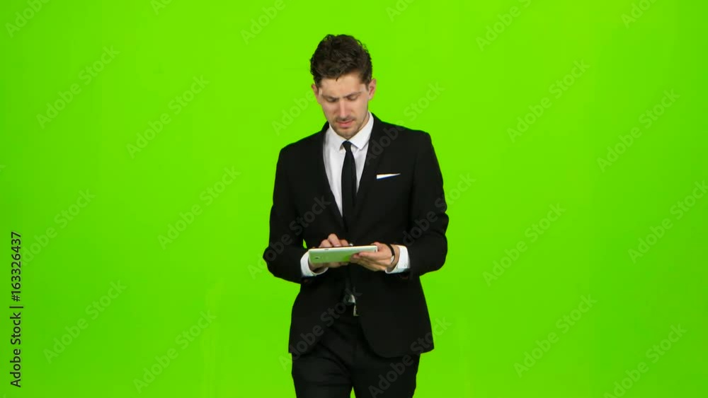 Businessman walks, thumbs a notebook, and makes a selfie. Green screen Businessman walks, thumbs a notebook, and makes a selfie. Green screen