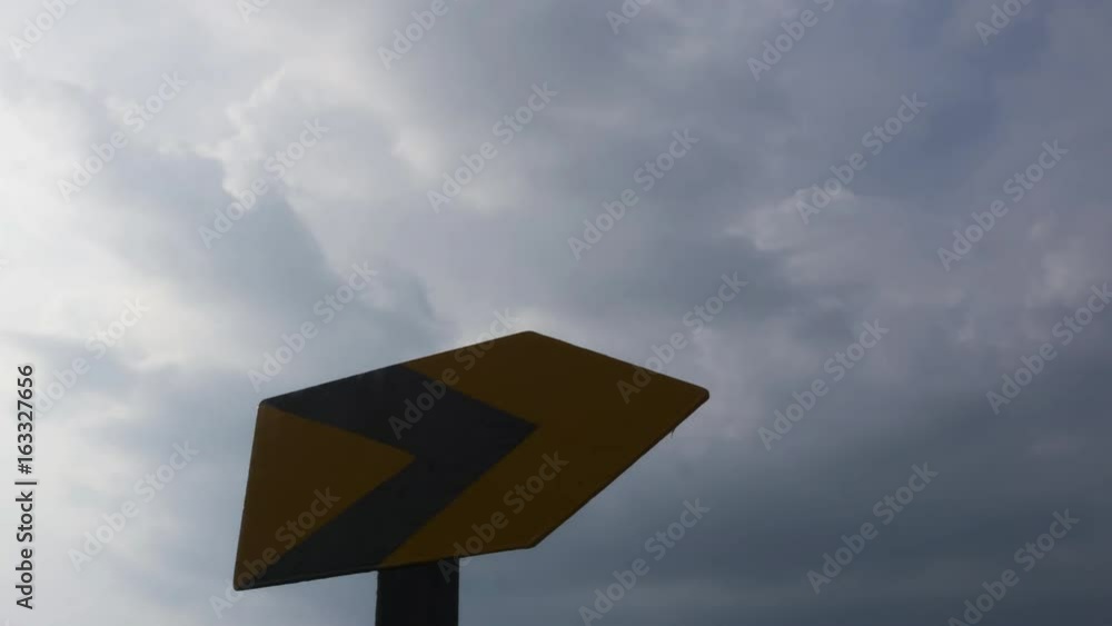 Timelapse shot of Arrow Sign at moving cloud sky background Timelapse shot of Arrow Sign at moving cloud sky background