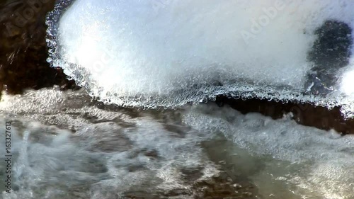 A beautiful crystal clear stream flows at Diane's bath in Bartlett, New Hampshire.  Interesting shapes of ice and snow are formed by the moving water.  Includes audio.  photo