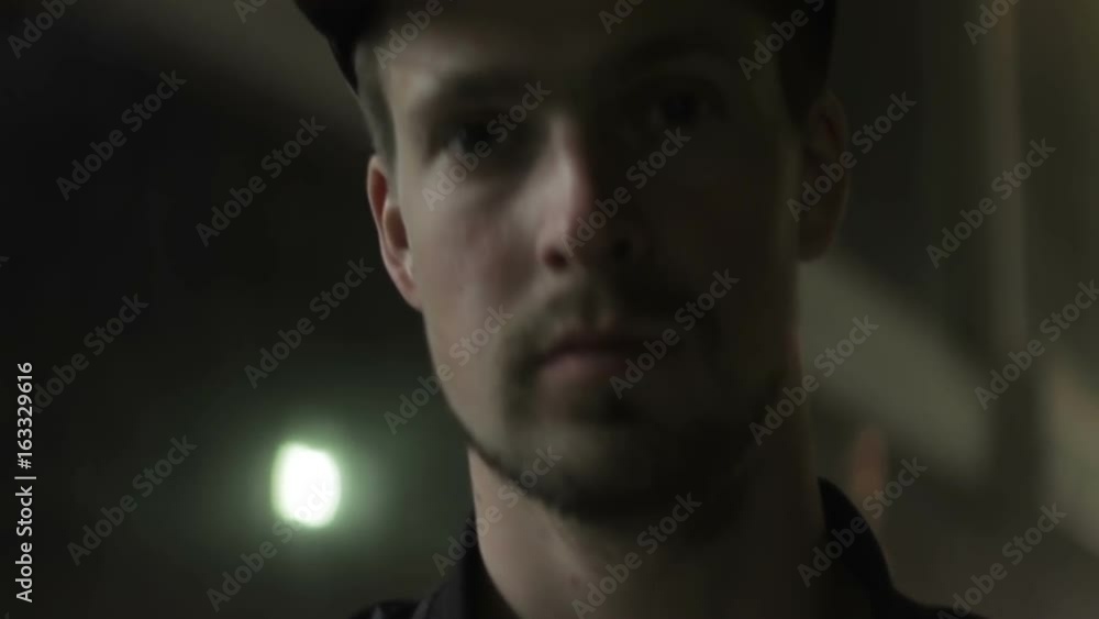 Face of a young man in a cap at night close-up