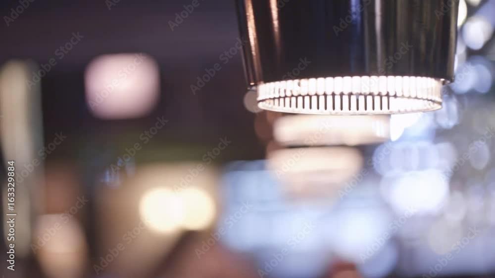 PAN of details of bar interior: modern lamp with soft light and wine glasses hanging on rack PAN of details of bar interior: modern lamp with soft light and wine glasses hanging on rack