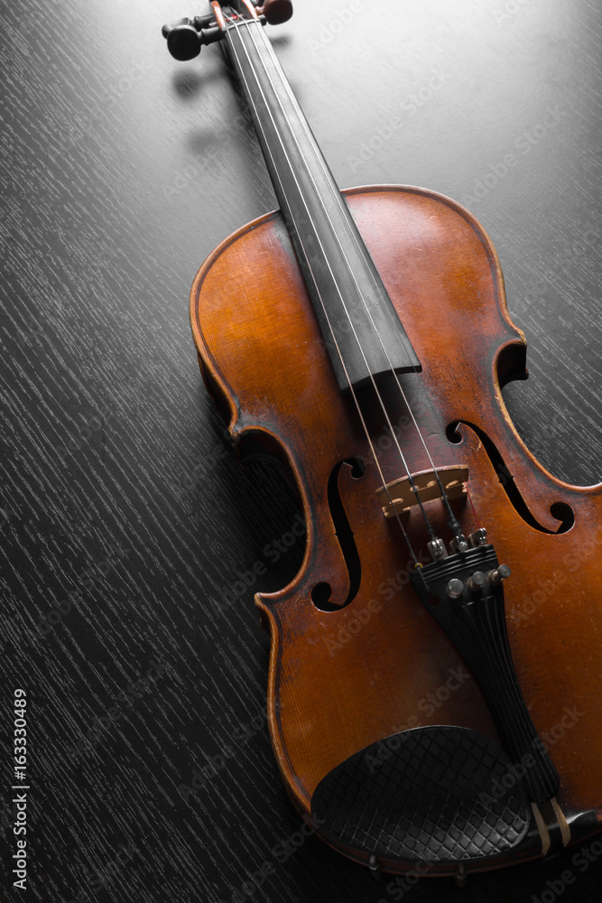 Fototapeta premium Old violin on a black background