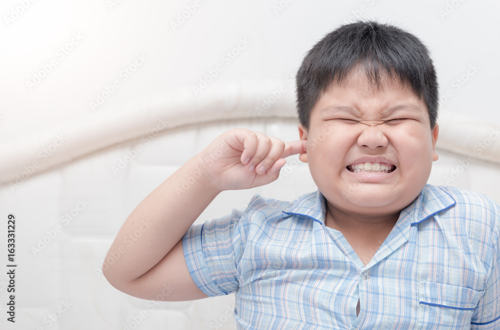 kid boy covered ears the fingers and gesturing kid boy covered ears the fingers and gesturing