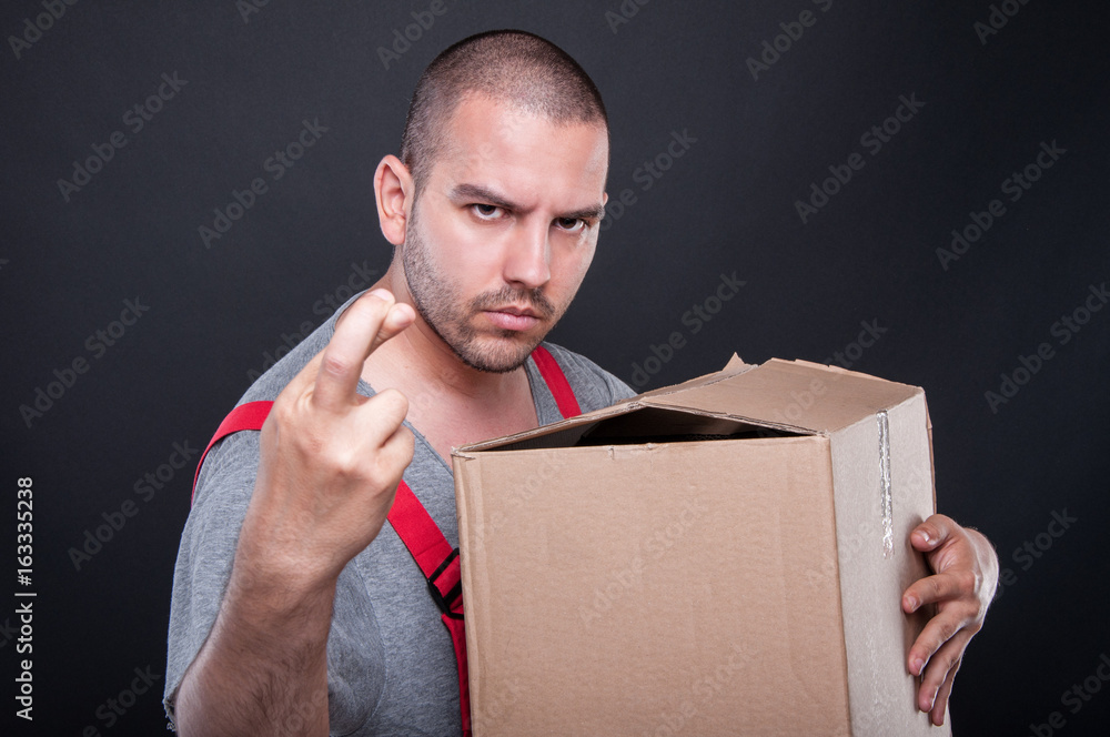 Mover man holding box wising bad luck with fingers crossed - obrazy, fototapety, plakaty 