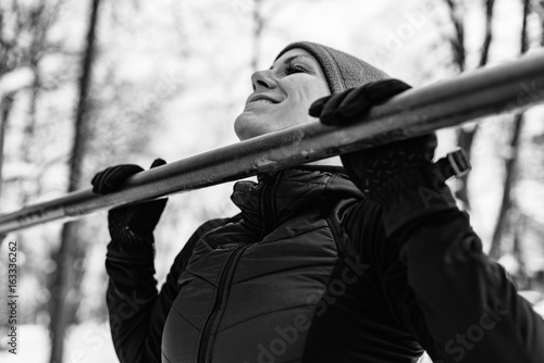 Female athlete exercising in park in winter