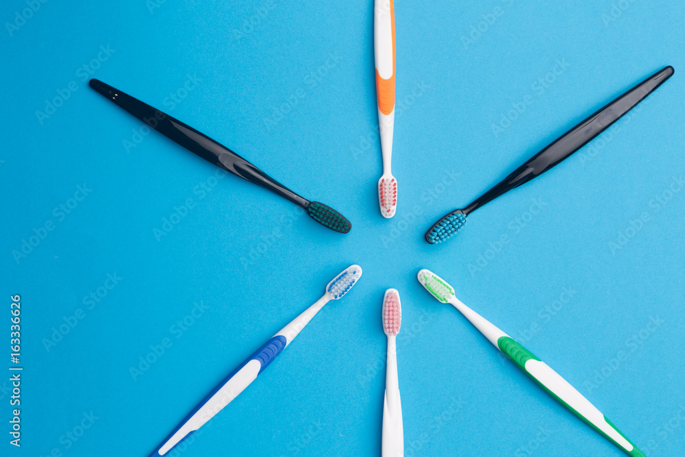Multi-colored toothbrushes arranged in circle Multi-colored toothbrushes arranged in circle