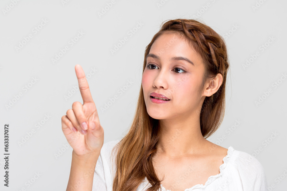 young latina girl pointing at the air. beauty and skincare concept. young latina girl pointing at the air. beauty and skincare concept.