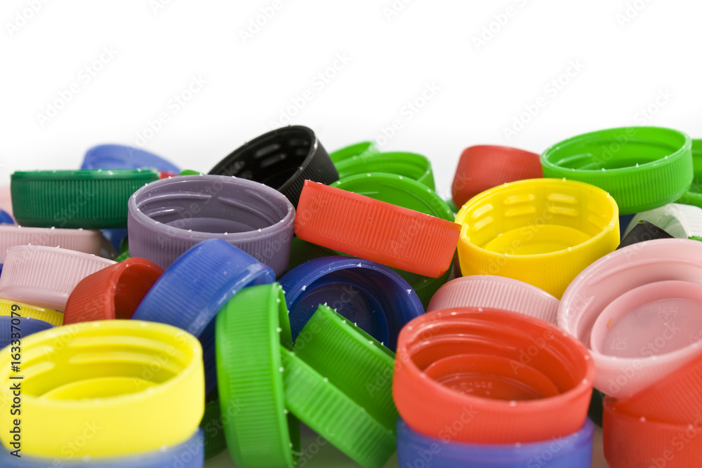 Colorful plastic bottle caps on white background. Still-life picture taken in studio with soft-box. Colorful plastic bottle caps on white background. Still-life picture taken in studio with soft-box.