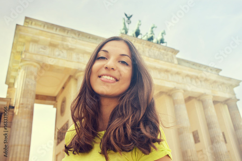 Photography Happy smiling girl in front of Brandenburg Gate, Berlin, Germany