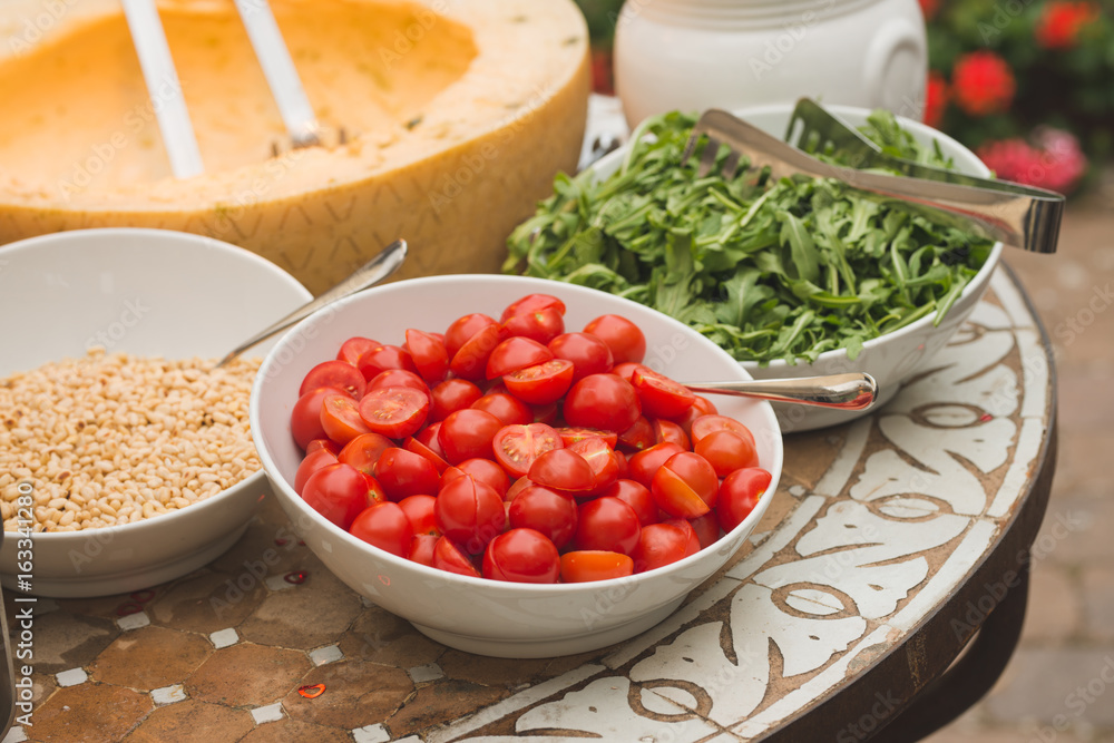 Pasta Inside a Cheese Wheel with tomato, pine nuts and arugula Pasta Inside a Cheese Wheel with tomato, pine nuts and arugula