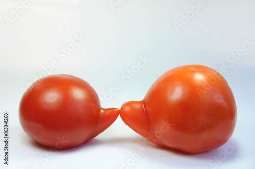 Two nosy tomatoes against each other 