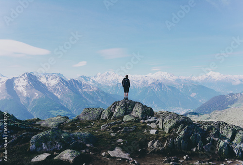 Hiker on mountain top rock. © Olga
