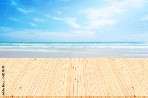 Empty white wooden table over blue sea background.