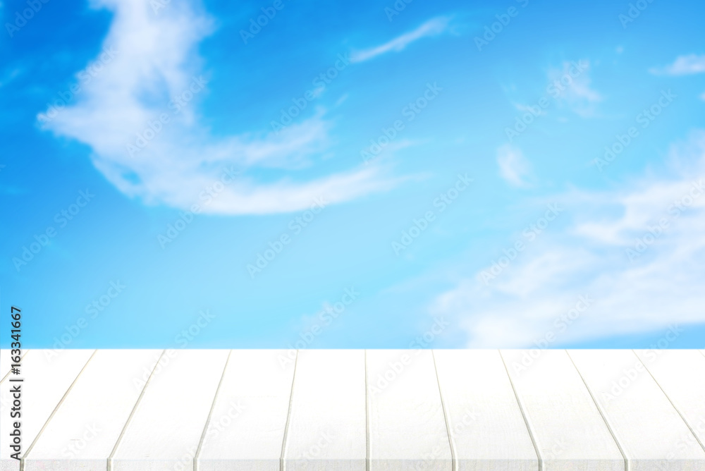 white wood table and blue sky background. white wood table and blue sky background.