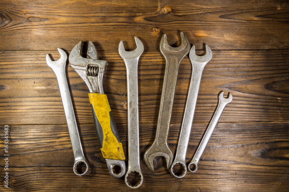 Old wrench tools on wooden background Old wrench tools on wooden background