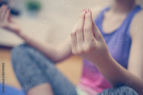 Close up of woman hands, doing yoga. Woman meditating at home, practicing yoga.