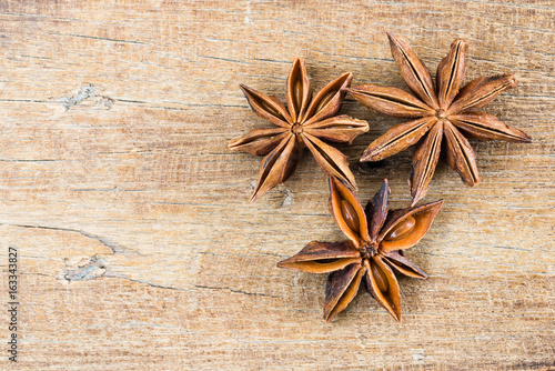 close up Chinese star anise on wood table texture background with copy space, top view