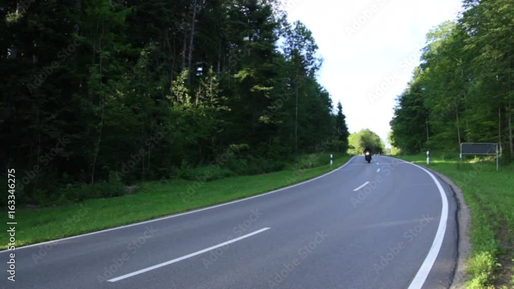 A biker riding a motorcycle on the road_4 A biker riding a motorcycle on the road_4