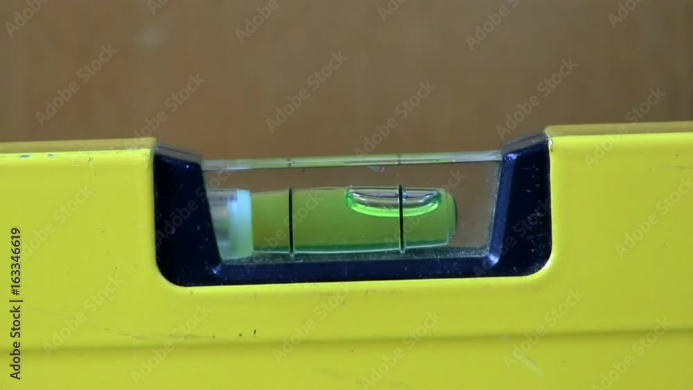 A bubble level is used to verify horizontal position by shimming left