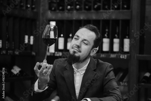 Young sommelier on red wine in cellar
