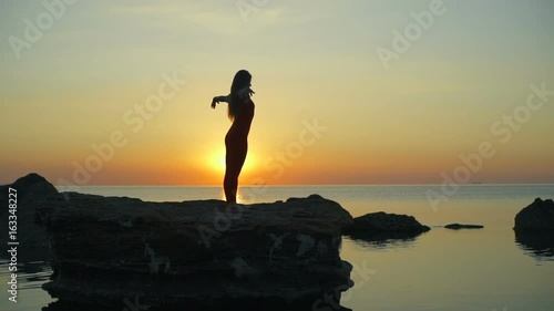 Silhouette girl do yoga namaste beautiful sundown rapid slow motion photo