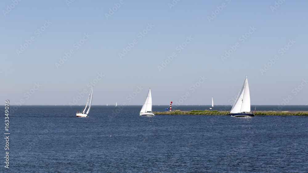 Sailing boats near entrance of harbor, Lelystad, Flevoland, Netherlands