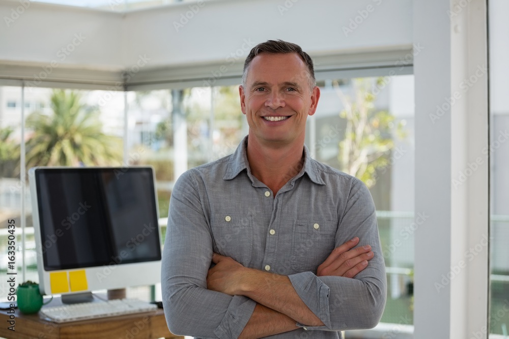 Portrait of confident businessman with arms crossed standing Portrait of confident businessman with arms crossed standing