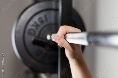 woman's hand on a barbell