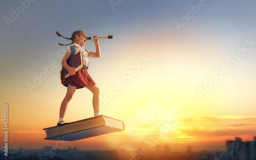 child flying on the book