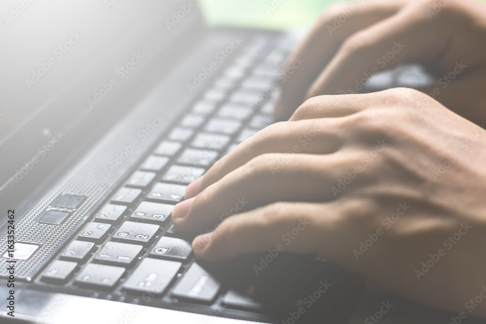 hands typing and searching for online education or information through laptop computer on vintage tone, selective focus hands typing and searching for online education or information through laptop computer on vintage tone, selective focus