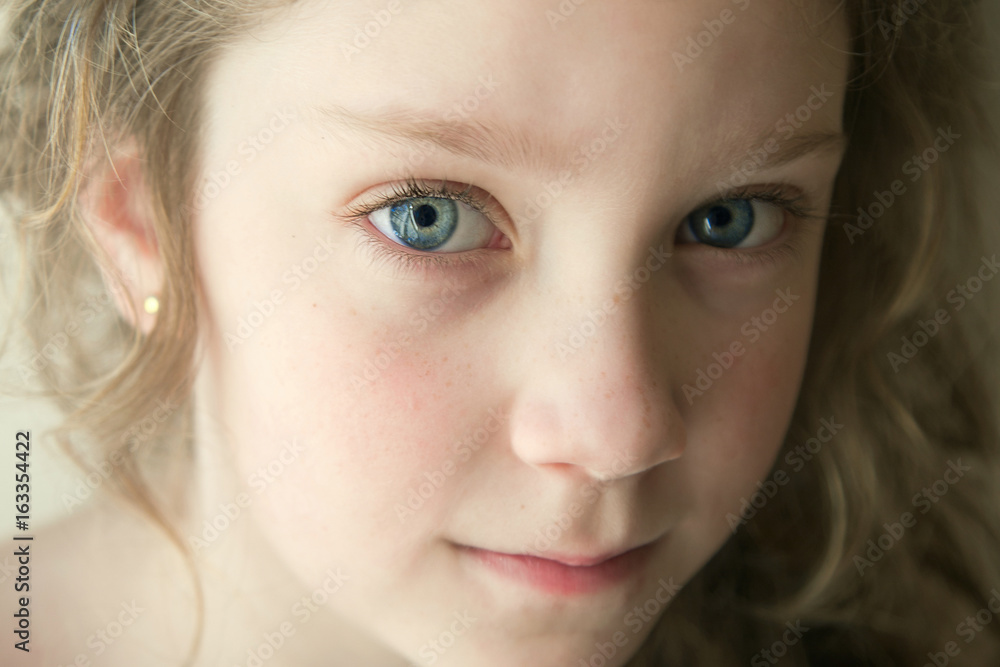 portrait of little girl with blue eyes with a serious look portrait of little girl with blue eyes with a serious look