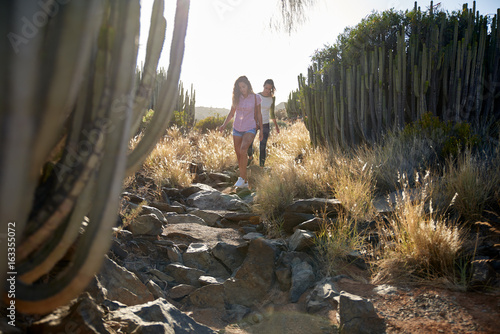 Girls climbing down a rocky path photo