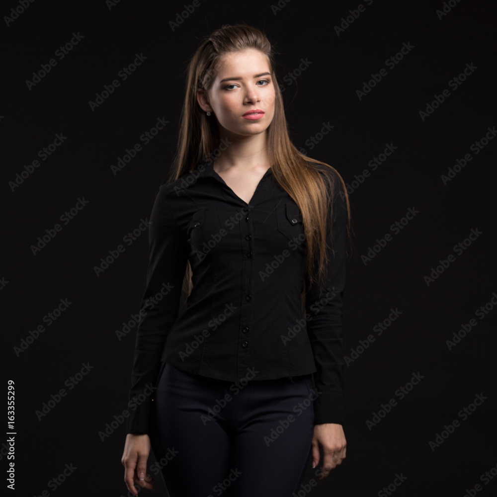 Young sexy woman portrait of a confident businesswoman showing presentation on a black background. Ideal for banners, registration forms, presentation, landings, presenting concept.. Young sexy woman portrait of a confident businesswoman showing presentation on a black background. Ideal for banners, registration forms, presentation, landings, presenting concept..