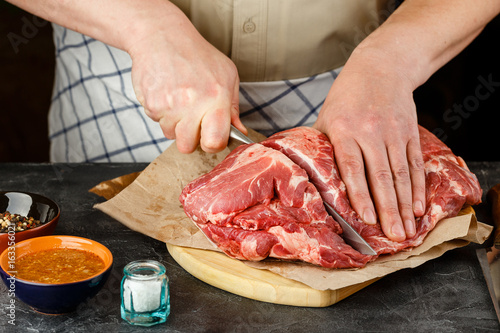 Close up of Male hands chopping knife pork