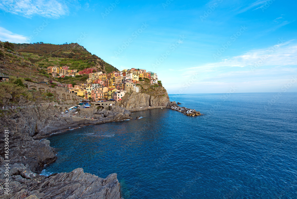 Charming beautiful landscape with bright colored houses on the rock on the seafront of Manarola in Cinque Terre, Liguria, Italy, Europe