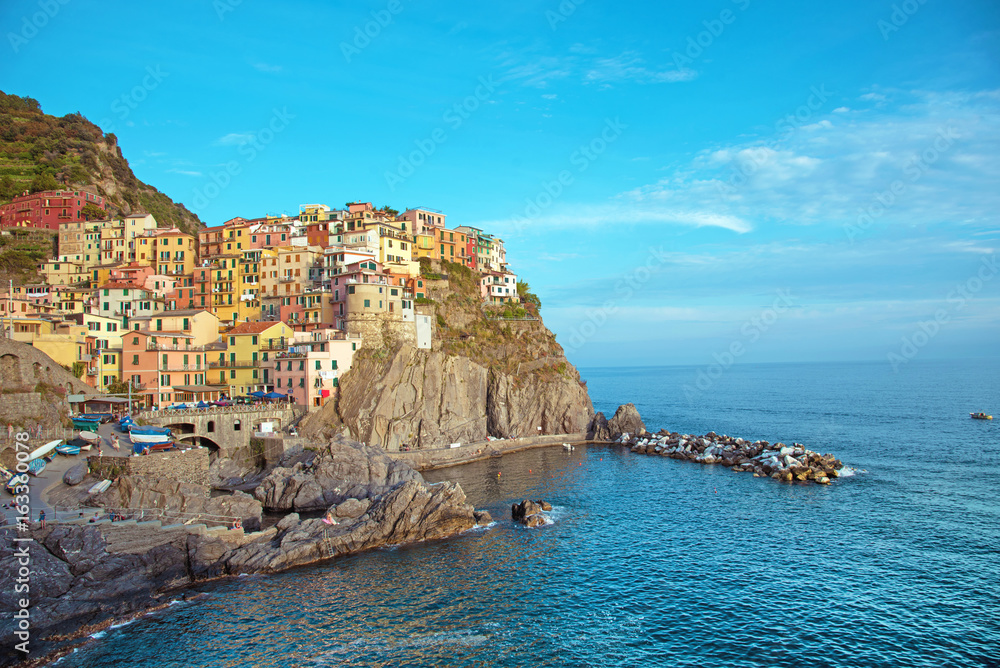 Charming beautiful landscape with bright colored houses on the rock on the seafront of Manarola in Cinque Terre, Liguria, Italy, Europe